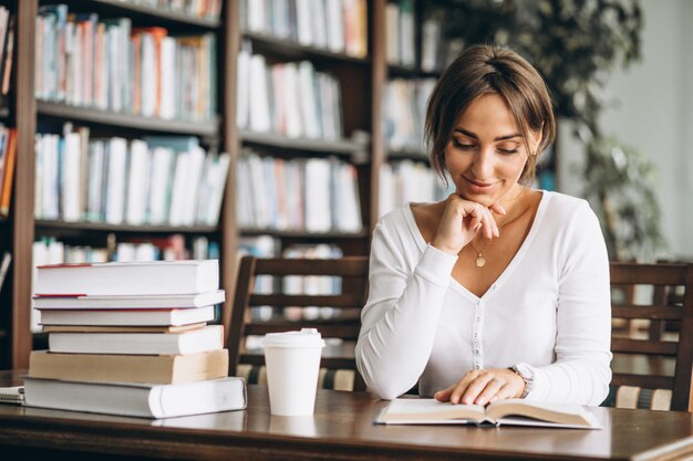 Mulher estudando para eleições da OAB na biblioteca